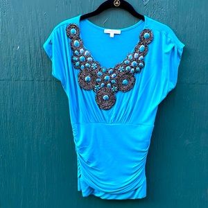 Beautiful ocean blue fitted tee with stone embellishment. Moa moa. Size med.